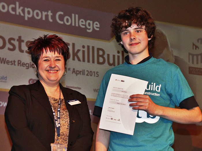 Alex receives his award from SkillBuild Competition hosts, Stockport College 